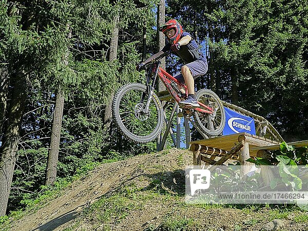 Jugendlicher auf Mountainbike  Drop mit Downhill-Bike im Bikepark Geißkopf  Bayerischer Wald  Bayern  Deutschland  Europa