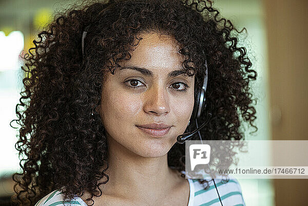 Portrait of young woman wearing headset