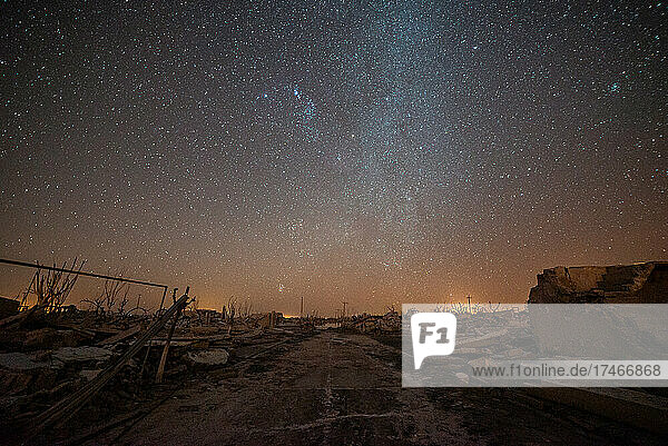 Scenic view of dirt road passing through abandoned village against milky way in sky  Villa Epecuen