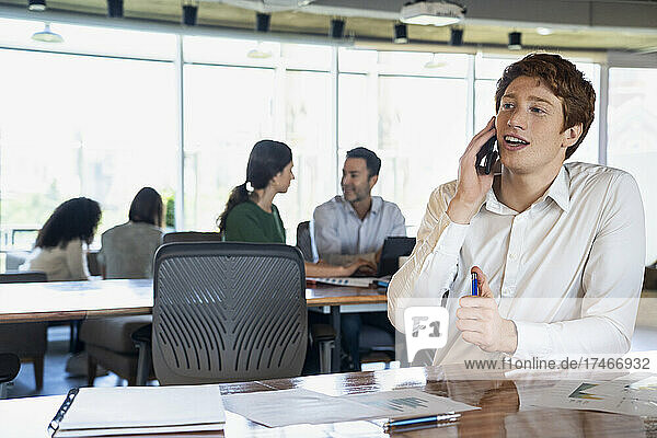 Portrait of young businessman talking on a smartphone