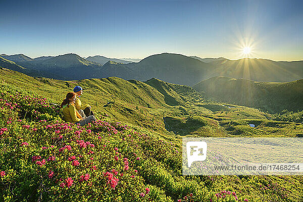 Hikers sitting amidst plants at Carinthia  Austria