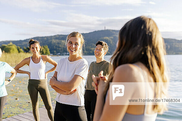 Smiling woman talking to instructor after yoga class