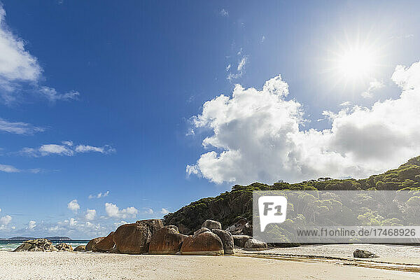 Sun shining over boulders lying at Squeaky Beach in Wilsons Promontory National Park