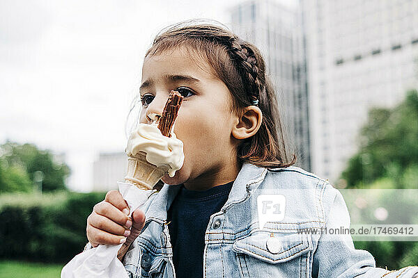 Girl eating ice cream at public park