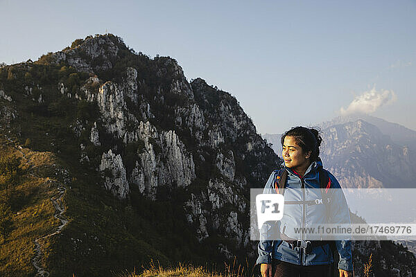 Young hiker standing on mountain