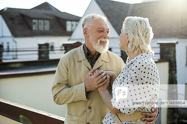 Smiling man looking at woman on rooftop