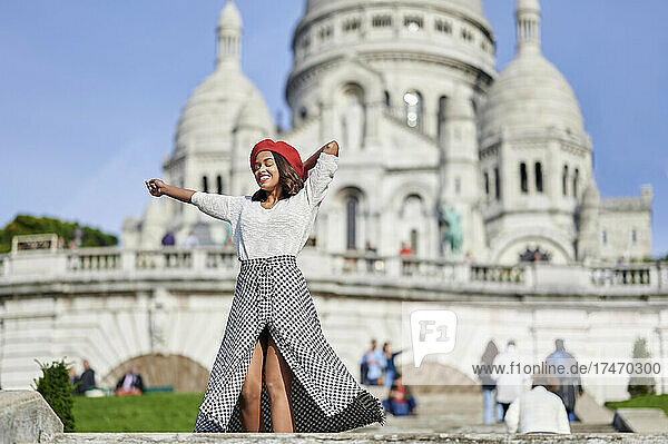 Young female tourist standing at Basilique Du Sacre Coeur  Montmartre in Paris  France