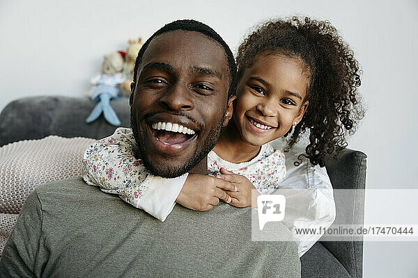 Happy father and daughter in living room