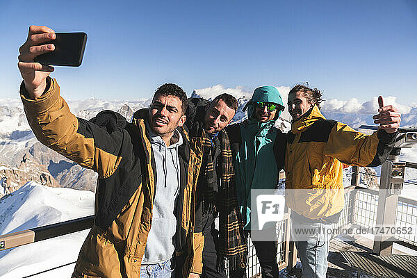 Friends taking selfie at viewpoint at Aiguille Du Midi  Mont Blanc  Chamonix  France