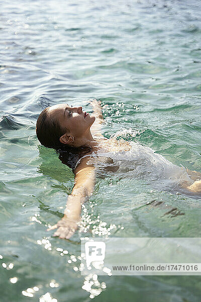 Woman swimming in sea on weekend