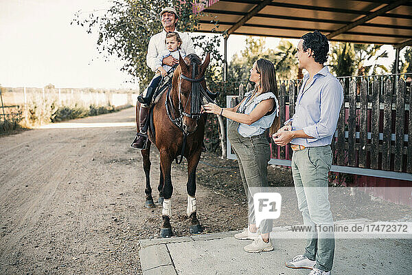 Family with horse on dirt road