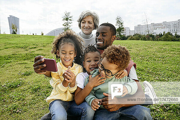 Mann macht Selfie mit Familie per Smartphone im Park