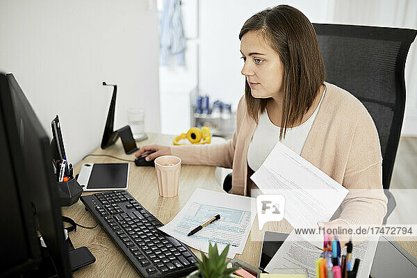 Businesswoman working on computer at desk
