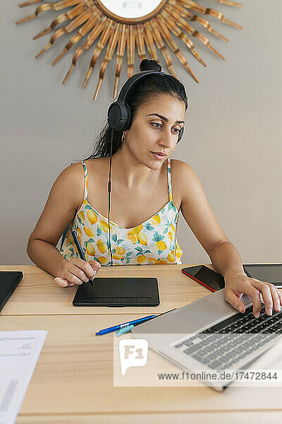 Young businesswoman working on laptop at home