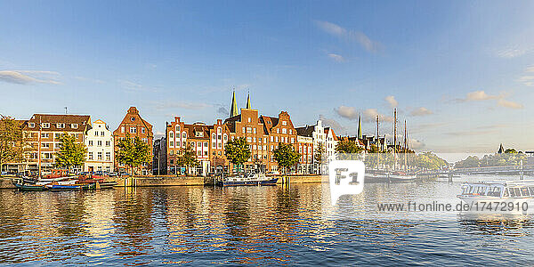 Germany  Schleswig-Holstein  Lubeck  Panoramic view of river Trave canal with historic townhouses in background