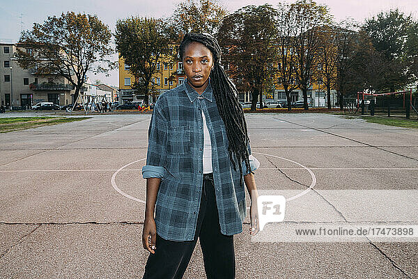 Young woman with locs hairstyle on sports court