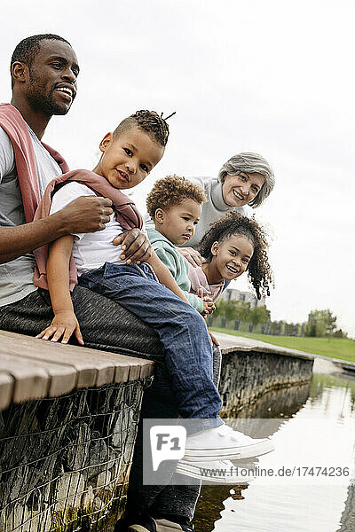 Family sitting together on pier at park