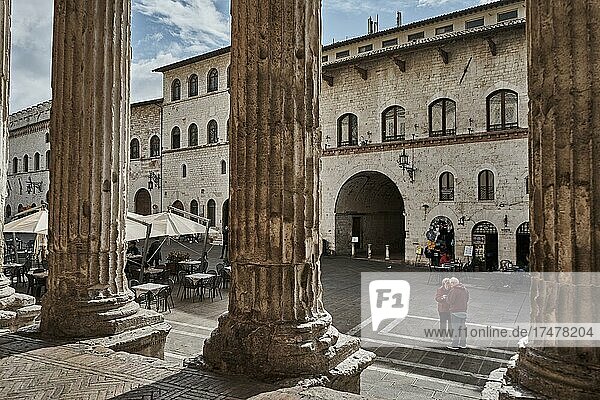 Columns from the former Temple of Minerva  now the Church of Santa Maria Sopra Minerva  opposite the Palazzo dei Priori (Town Hall) in the Piazza del Comune  Assisi  Umbria  Italy  Europe