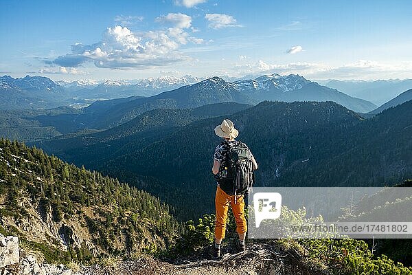 Hikers on a hiking trail  view into the distance  ridge walk Herzogstand Heimgarten  Soierngruppe at the back  Upper Bavaria  Bavaria  Germany  Europe