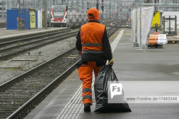 Man dragging rubbish bag  Switzerland  Europe