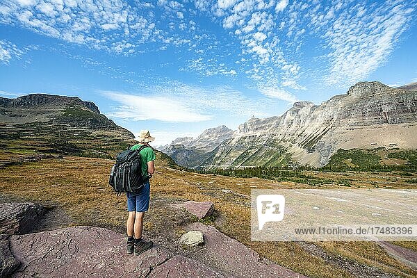 Hikers on a hiking trail  Hidden Lake Trail  Mount Oberlin and Bishops Cap in the background  Glacier National Park  Rocky Mountains  Montana  USA  North America