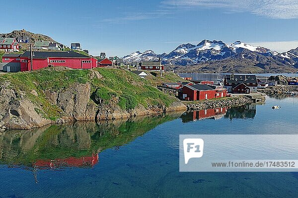 Häuser am seichten Ufer eines Fjordes  schneebedeckte Berge  Tasilaq  Arktis  Ostgrönland  Grönland  Dänemark  Nordamerika