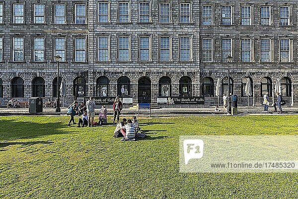 Students on a lawn in front of the library of Trinity College  Dublin  Ireland  Europe