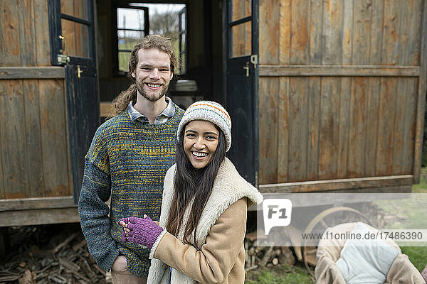 Porträt glückliches junges Paar vor winziger Hüttenvermietung