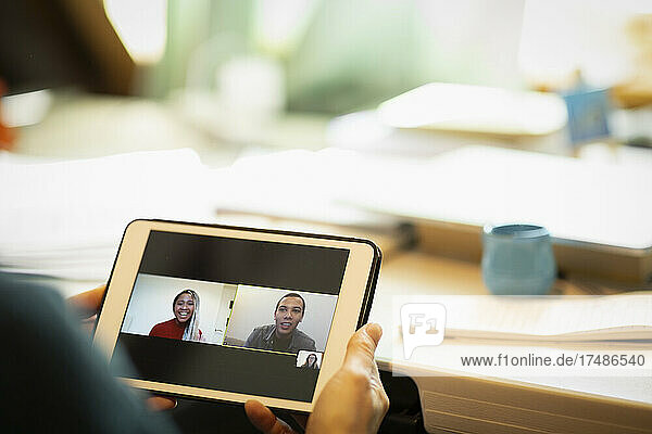 Colleagues video chatting on digital tablet screen
