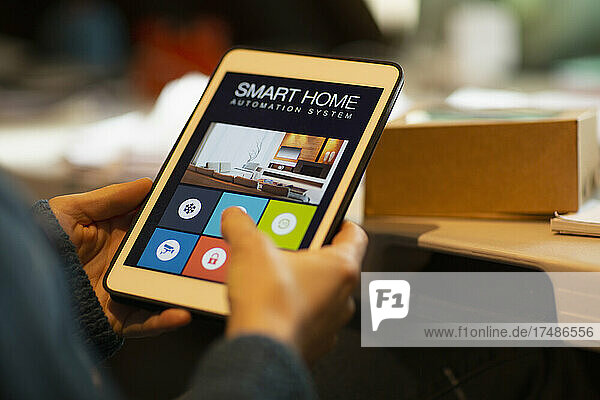 Close up woman looking at home automation on digital tablet