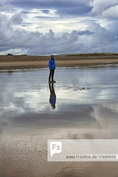 Man standing on the beach in the evening  looking at the sea  Keel beach  Acaill  Achill Island  Mayo  Wild Atlantic Way  Ireland  Europe