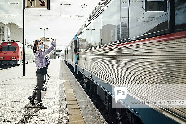 Winken und Verabschiedung auf dem Bahnsteig des Bahnhofs von jemandem  der mit dem Zug abreist