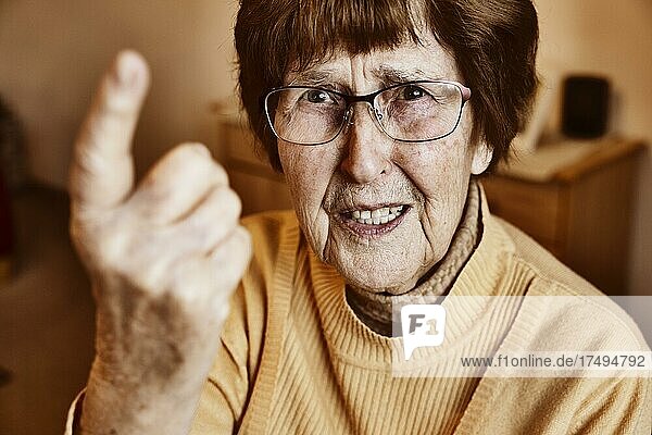 Angry senior citizen threatens with her raised index finger  Cologne  North Rhine-Westphalia  Germany  Europe