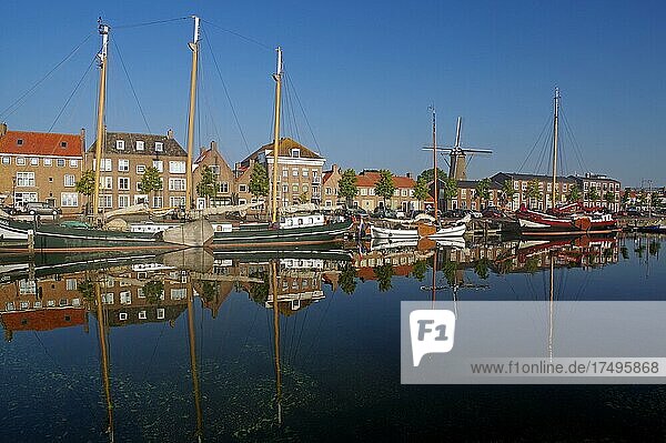 Old ships and houses reflected in the harbour basin  Hellevoetsluis  South Holland  Netherlands
