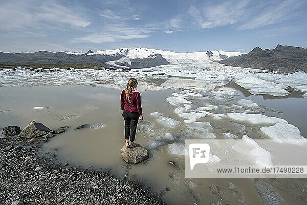 Woman in front of Fjallsárlón ice lagoon  ice floes in front of Vatnajökull glacier  Hornafjörður  Iceland  Europe
