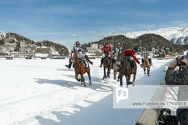 Players from Team St. Moritz (red) and players from Team Azerbaijan Land of Fire (white) fight for the ball on the rail  36th Snow Polo World Cup St. Moritz 2020  Lake St. Moritz  St. Moritz  Grisons  Switzerland  Europe