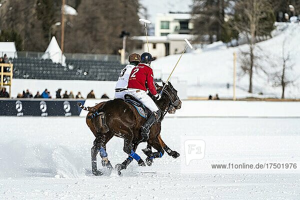 Robert Strom (red) of Team St. Moritz and Santiago Marambio (white) of Team Azerbaijan Land of Fire ride side by side across the field at full gallop  36th Snow Polo World Cup St. Moritz 2020  Lake St. Moritz  St. Moritz  Grisons  Switzerland  Europe