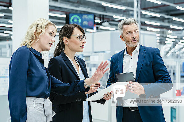 Businesswoman explaining colleagues at electrical industry