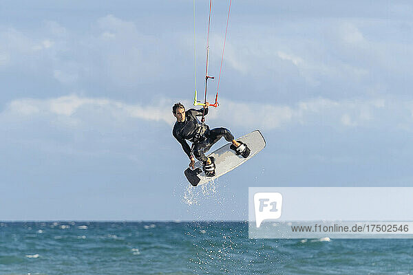 Man kiteboarding over water on vacation