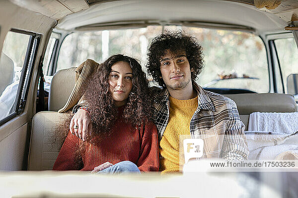 Young couple sitting in campervan
