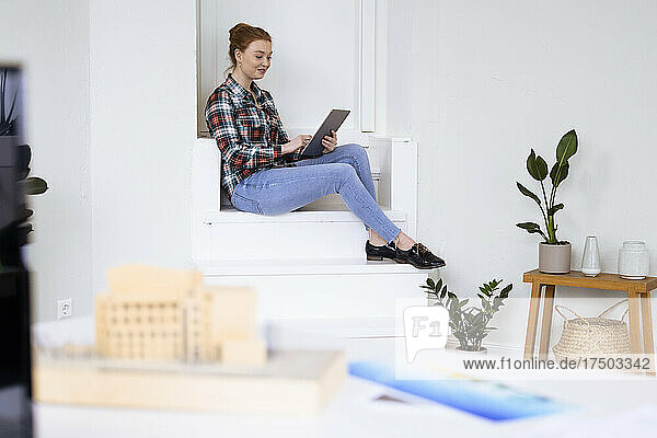 Young businesswoman using tablet PC on steps