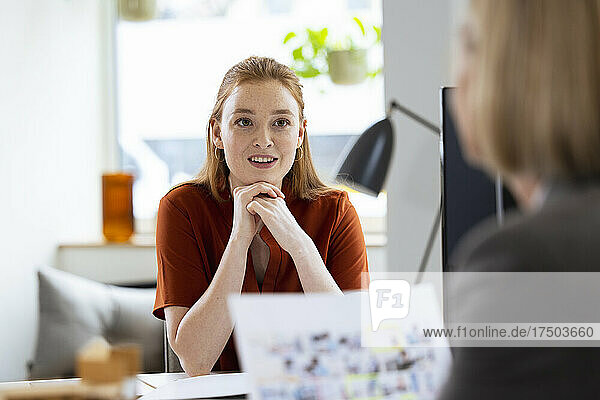 Businesswoman discussing with colleague in office