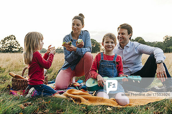 Happy family enjoying picnic at park