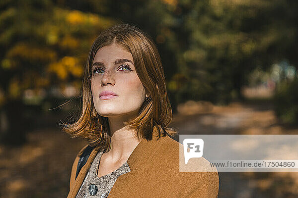 Young woman contemplating in park