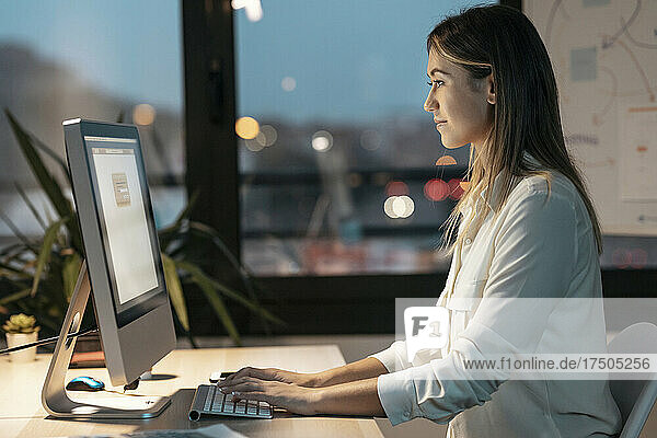 Young businesswoman working on computer in office