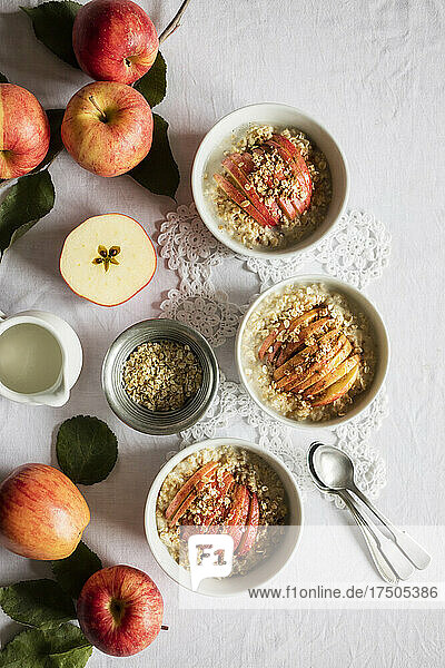 Studio shot of bowls of fresh porridge with Gala apples 