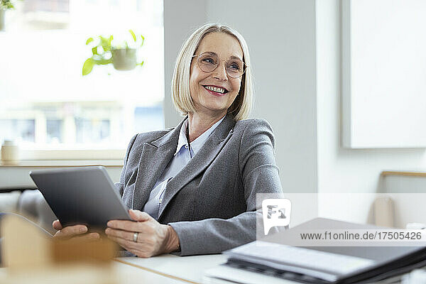 Businesswoman with tablet PC at workplace