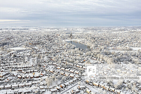 UK  England  Lichfield  Aerial view of snow-covered city with small lake in background
