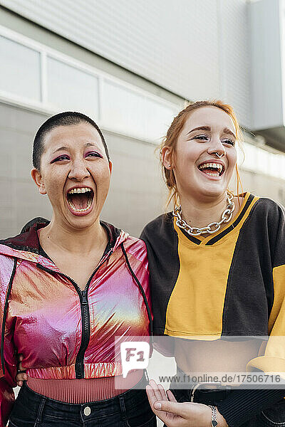 Cheerful multiracial women laughing together