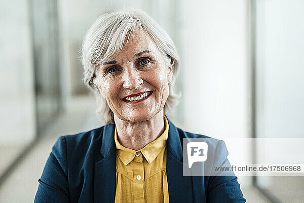 Senior businesswoman smiling at office